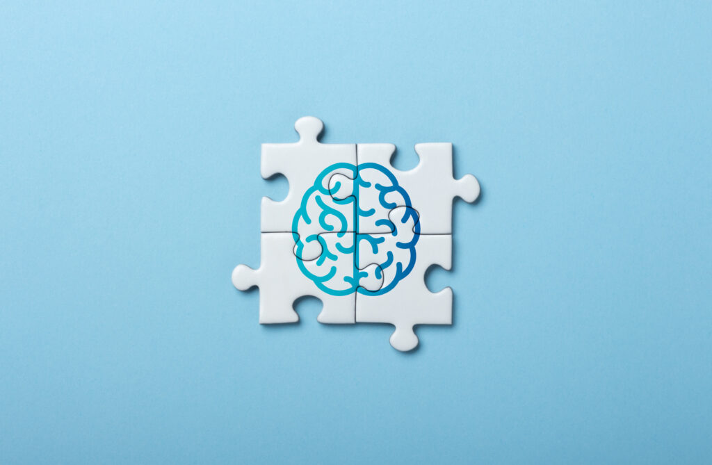 Brain Illustration on Puzzle Pieces Symbolizing Mind and Cognitive Concepts